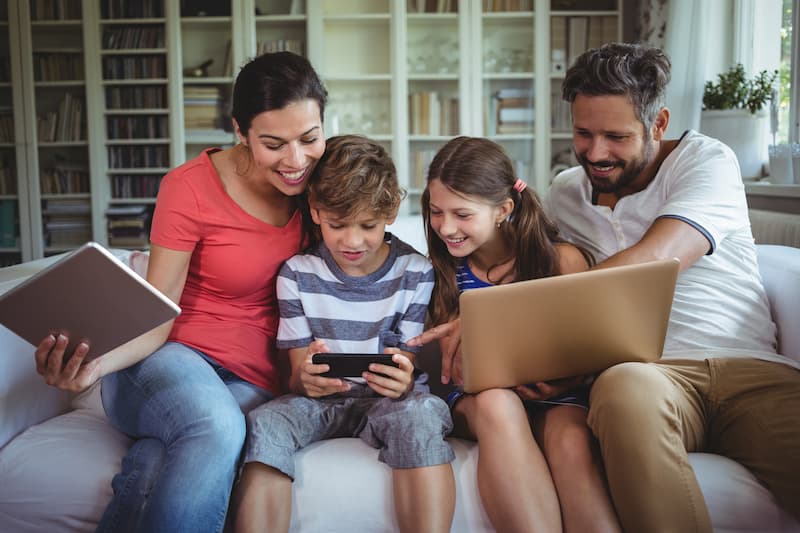 Happy family using high-speed internet at home with Ripple Broadband's residential services